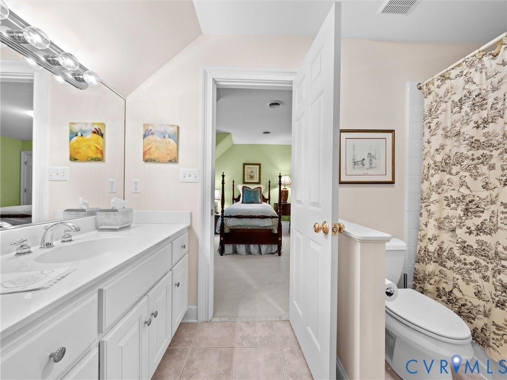 White vanity with an integrated sink, polished chrome faucet, and ample storage cabinetry