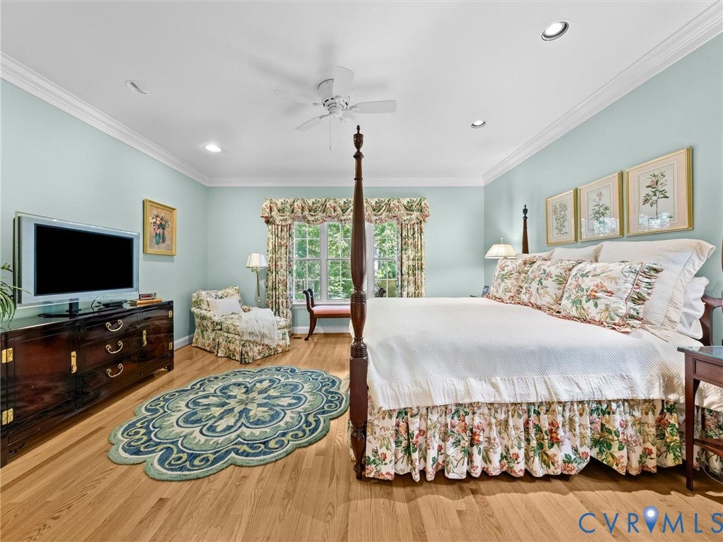 Hardwood flooring, recessed lighting, crown molding, ceiling fan, and large window