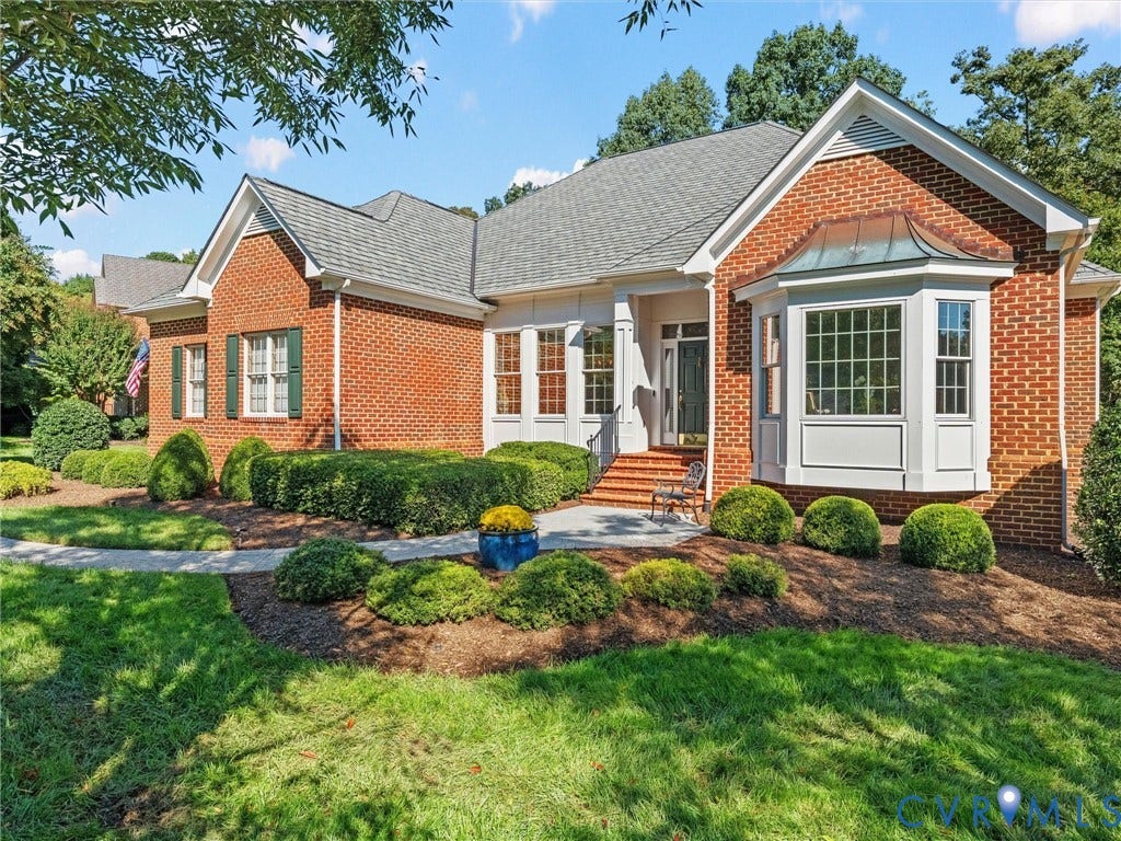 Brick exterior with a gray shingle roof