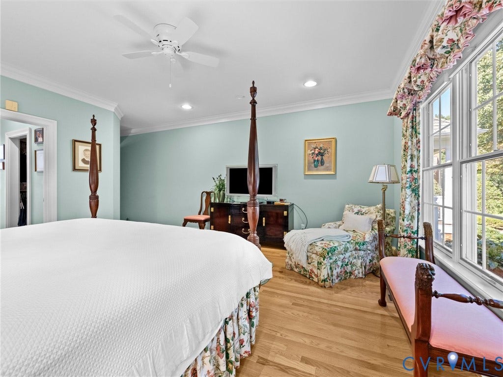 Recessed lighting, crown molding, wood-finish flooring, ceiling fan, and large windows