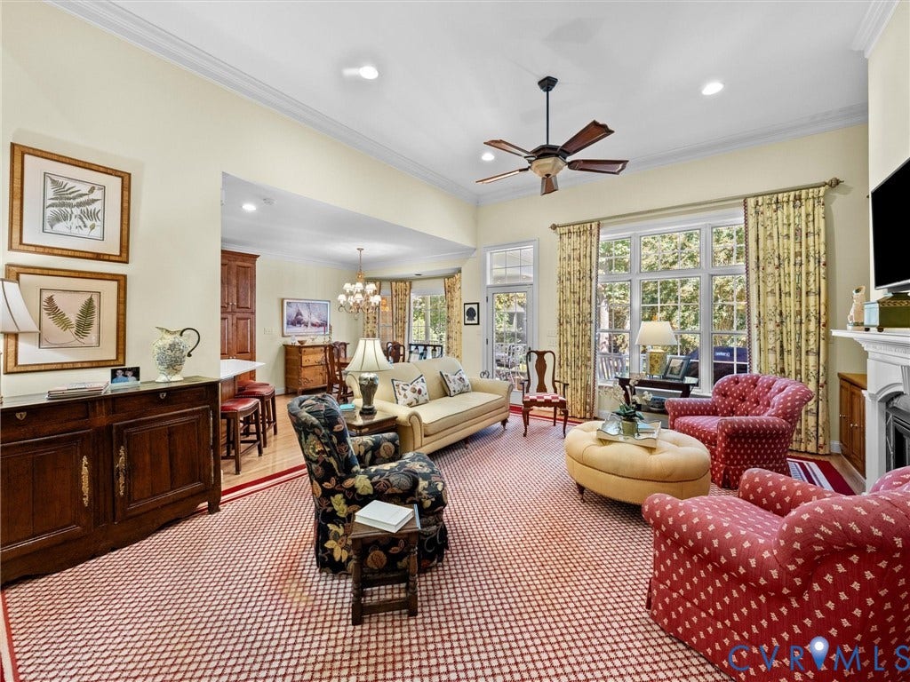 Recessed lighting illuminates the high ceilings with crown molding