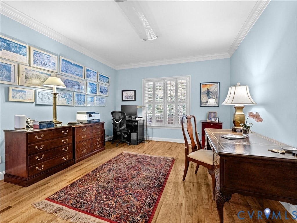 Hardwood flooring, crown molding, window with plantation shutters, light blue wall paint