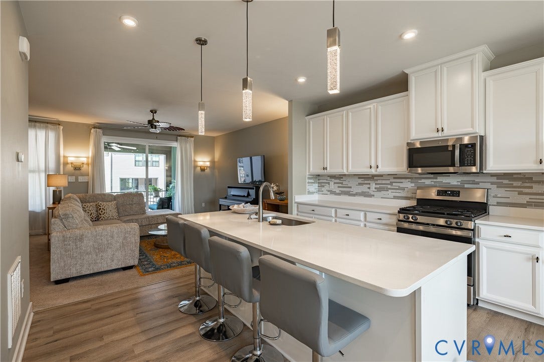 14336 Altavista Boulevard, Midlothian, VA 23114 Kitchen with white cabinetry, stainless steel appliances, and a mosaic tile backsplash