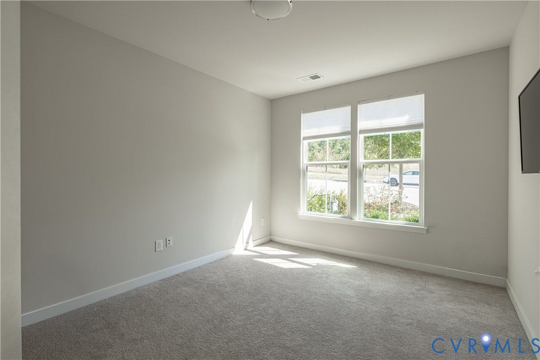 14336 Altavista Boulevard, Midlothian, VA 23114 Bright corner bedroom with abundant natural light from large dual-pane windows, neutral wall finishes, and neutral carpet flooring