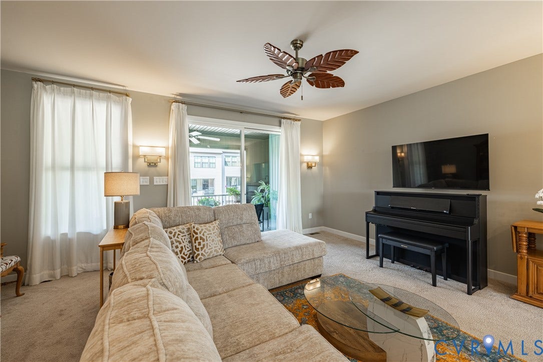 14336 Altavista Boulevard, Midlothian, VA 23114 Carpeted living area featuring a ceiling fan, wall sconces, and sliding glass doors to a balcony