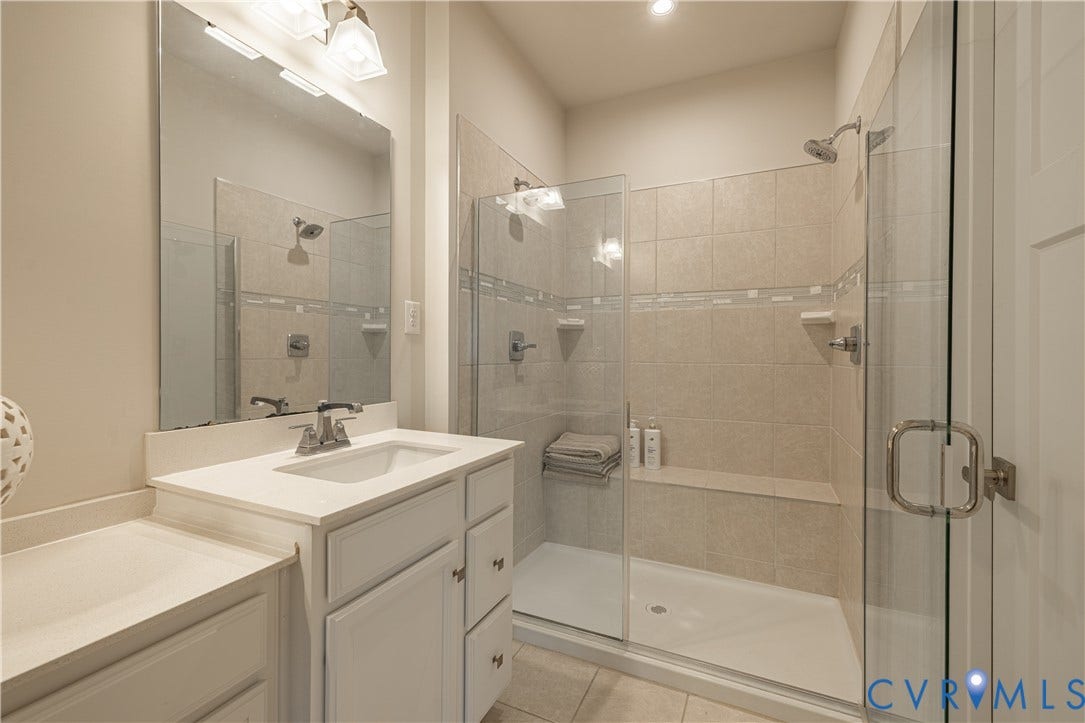 14336 Altavista Boulevard, Midlothian, VA 23114 Vanity with white cabinetry and integrated sink, chrome faucet, and expansive wall-mounted mirror