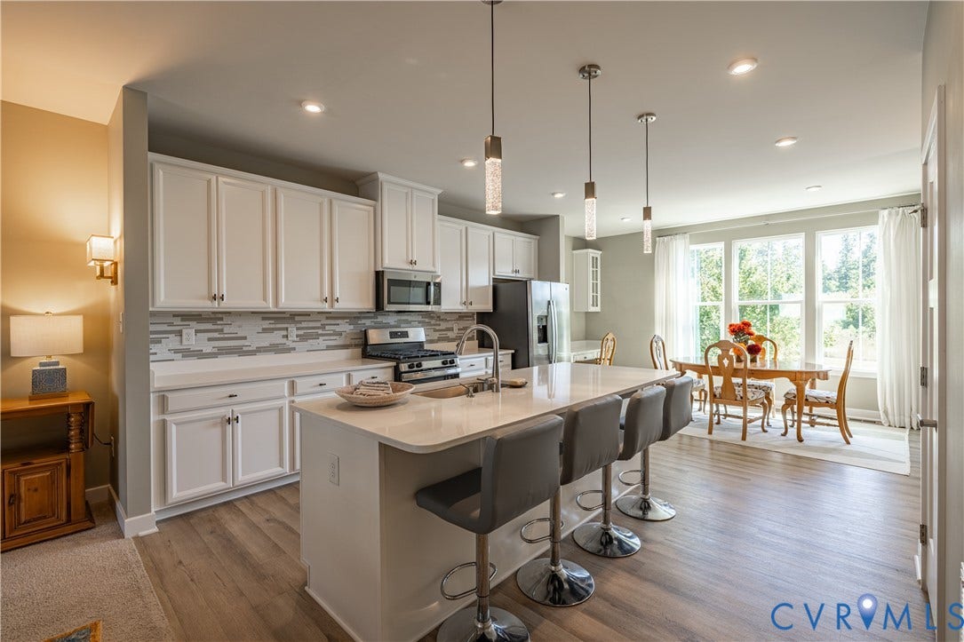 14336 Altavista Boulevard, Midlothian, VA 23114 White cabinetry, peninsula island with a light-toned countertop, wood-finish flooring, stainless steel appliances, and recessed lighting
