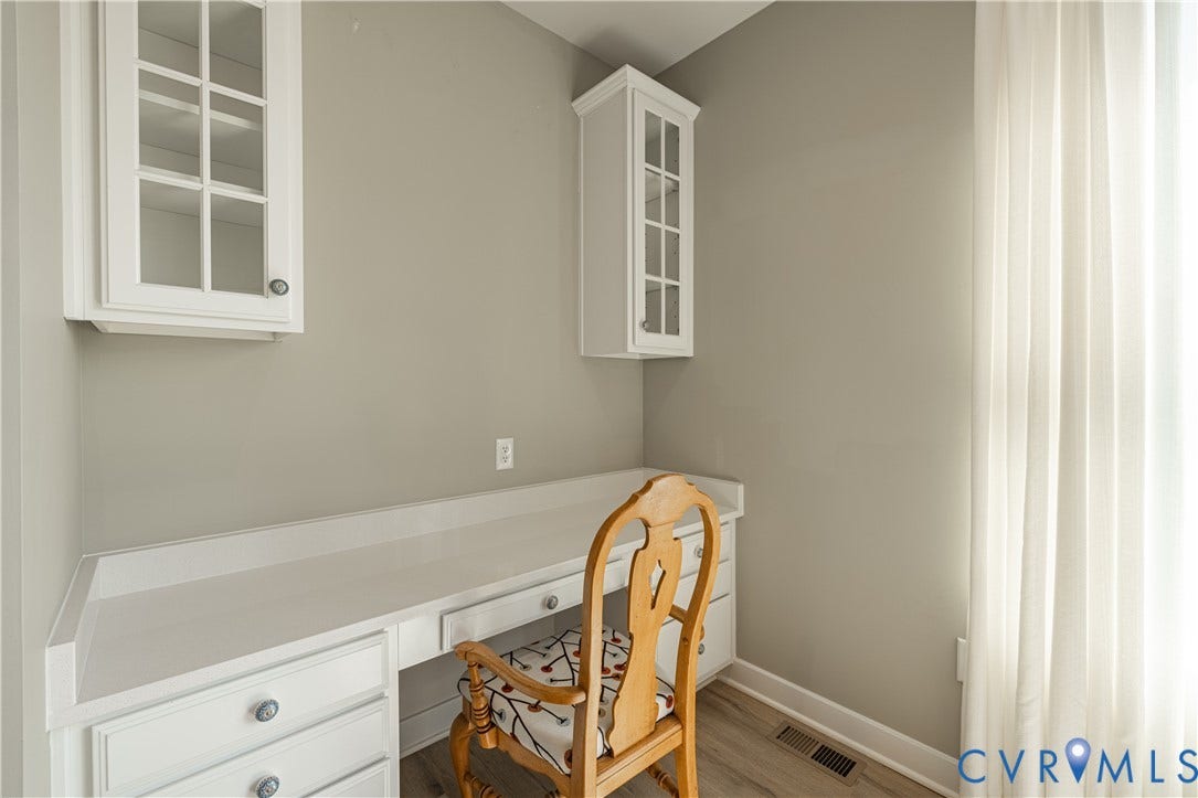 14336 Altavista Boulevard, Midlothian, VA 23114 Integrated desk area with a light-toned countertop, white cabinetry with clear glass panels, and wood-finish flooring