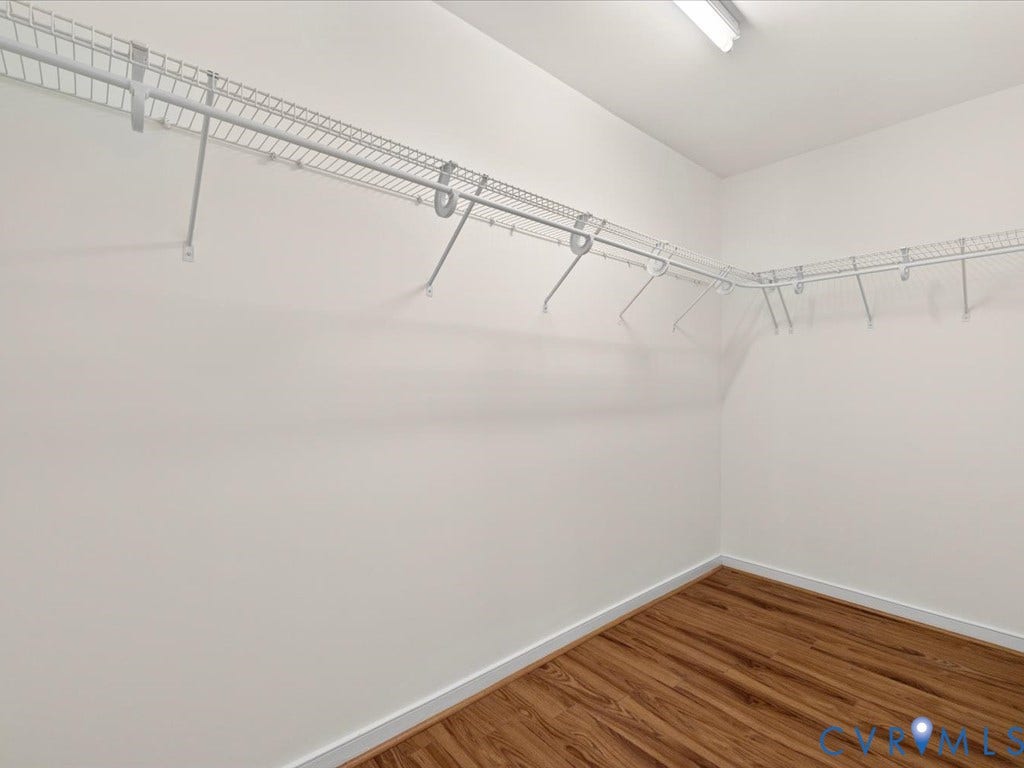 White wire shelving system, recessed ceiling lighting, and wood-finish flooring