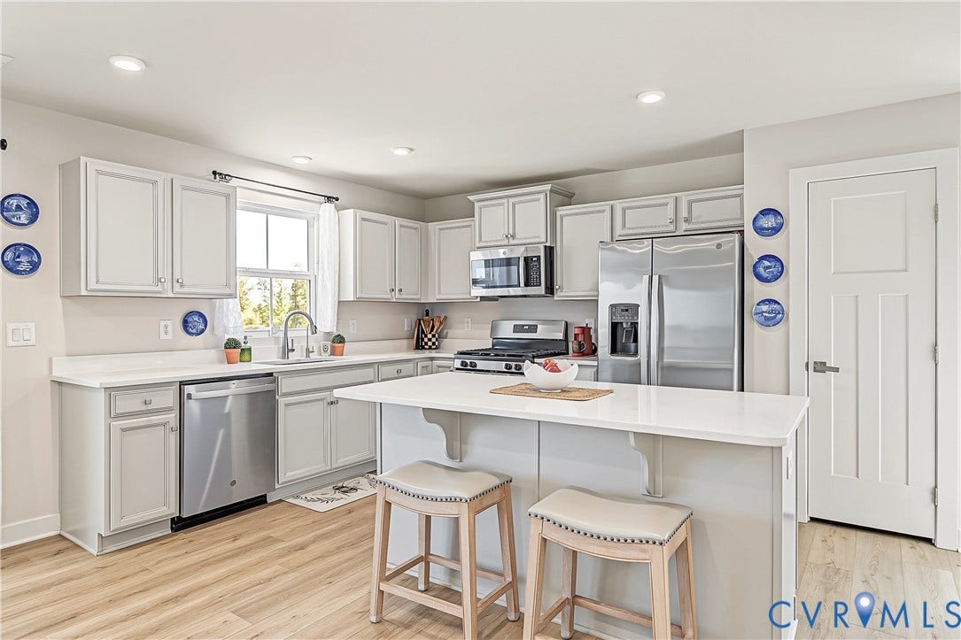 7490 E Danube Loop, The Groves, New Kent, VA 23124 Modern kitchen offering stainless steel appliances and center island/breakfast bar