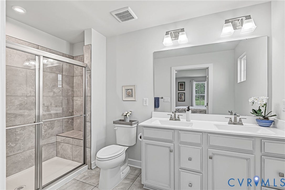 7490 E Danube Loop, The Groves, New Kent, VA 23124 Well-appointed ensuite with generous vanity space and a glass-enclosed step-in shower