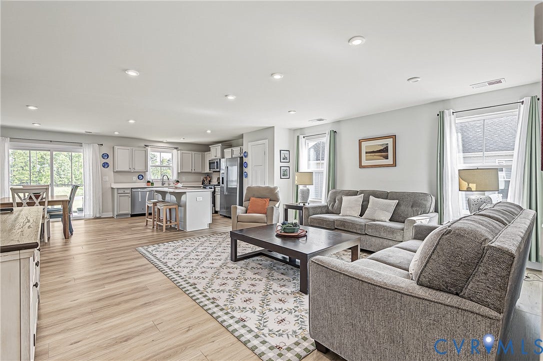 7490 E Danube Loop, The Groves, New Kent, VA 23124 Bright open-concept living room with new LVP flooring (2026) and recessed lighting