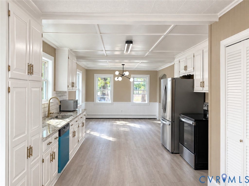 207 S Mesa Drive, Hopewell, VA 23860 Kitchen featuring white cabinetry with gold-tone hardware, a stainless steel refrigerator, and a built-in dishwasher