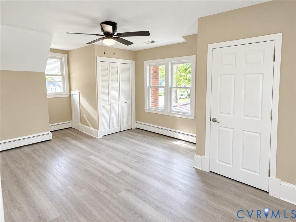207 S Mesa Drive, Hopewell, VA 23860 Wood-finish flooring, multiple windows, white paneled doors, and a ceiling fan with integrated lighting
