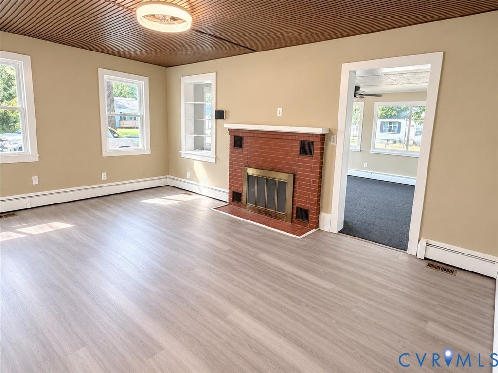 207 S Mesa Drive, Hopewell, VA 23860 Wood-finish flooring with a brick fireplace, built-in shelving, white trim, and a decorative ceiling