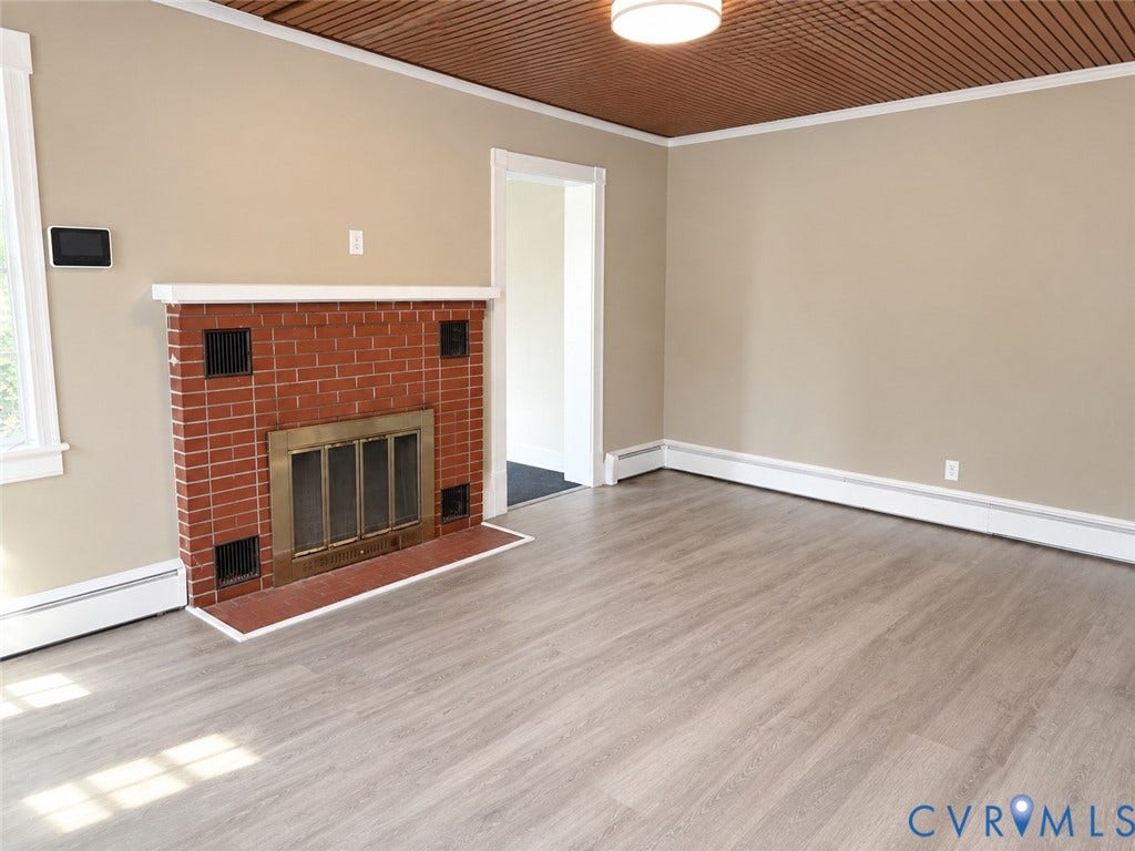207 S Mesa Drive, Hopewell, VA 23860 Red brick fireplace with a white mantel, wood-finish flooring, and a coffered ceiling