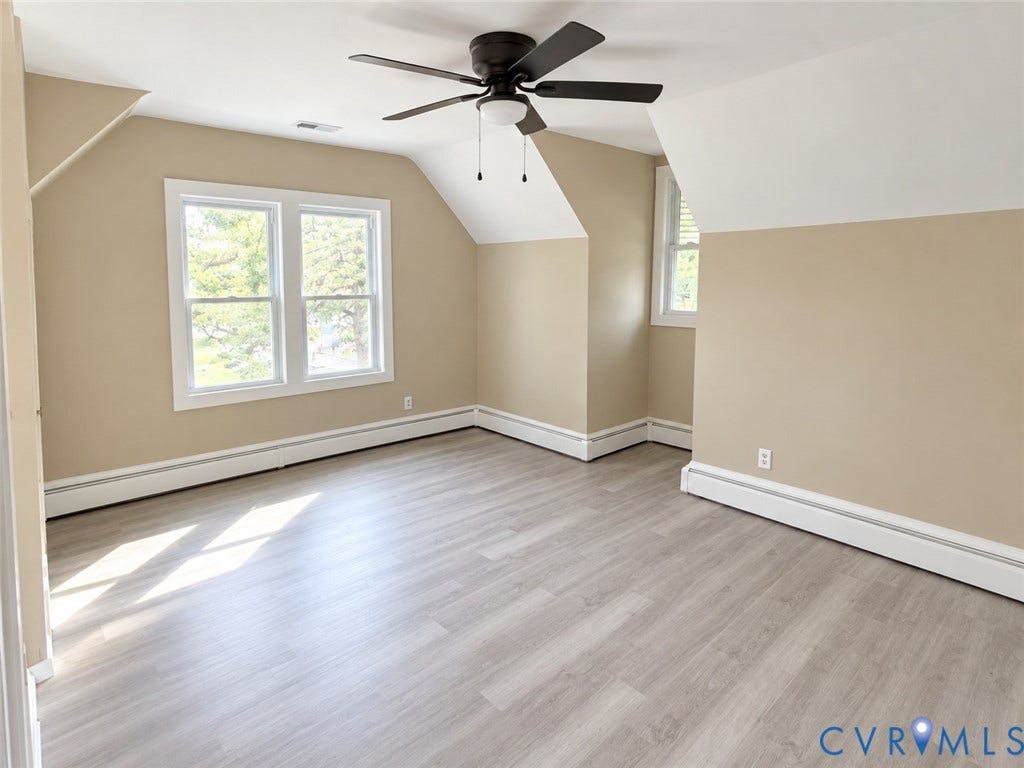 207 S Mesa Drive, Hopewell, VA 23860 Room featuring light wood-finish flooring, a ceiling fan with integrated lighting, and multiple windows
