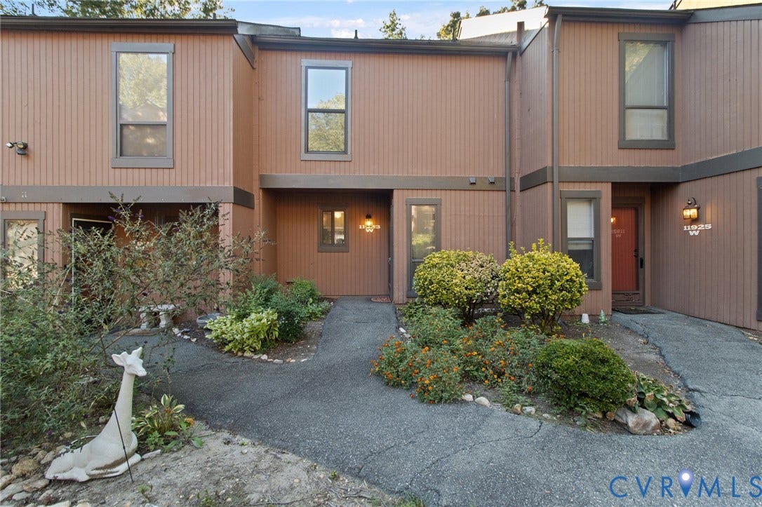 Two-story exterior with vertical siding and multiple windows