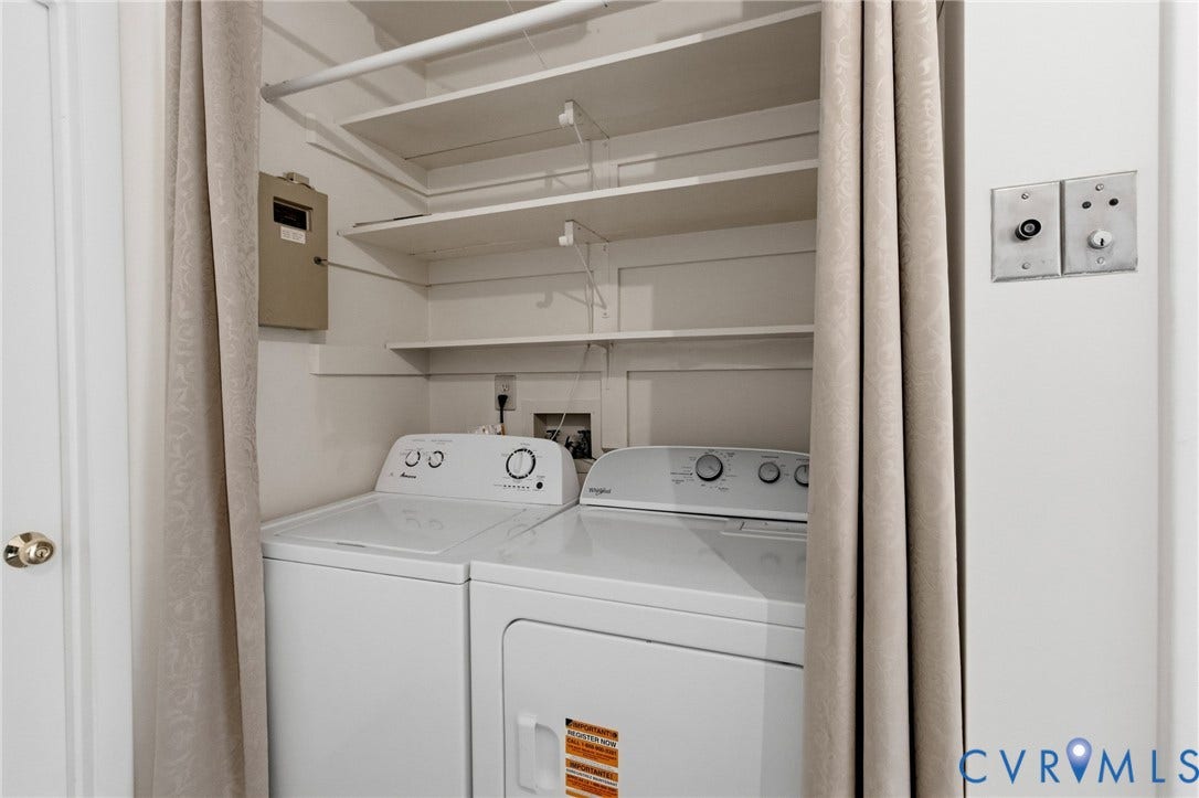 Laundry area with built-in shelving, a clothes hanging rod, and white appliances
