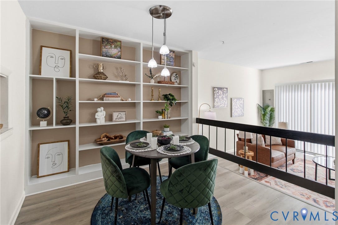 Built-in shelving unit, wood-finish flooring, staircase with metal balusters, and a contemporary pendant light fixture