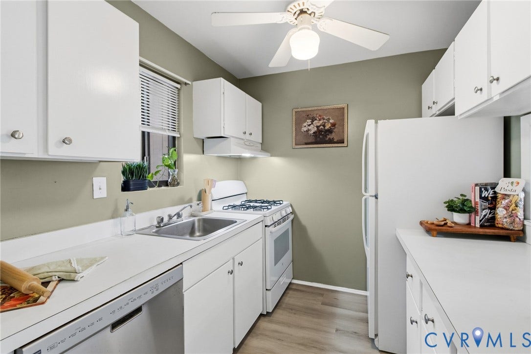 Kitchen featuring white cabinetry, white appliances, durable countertops, wood-finish flooring, and a ceiling fan