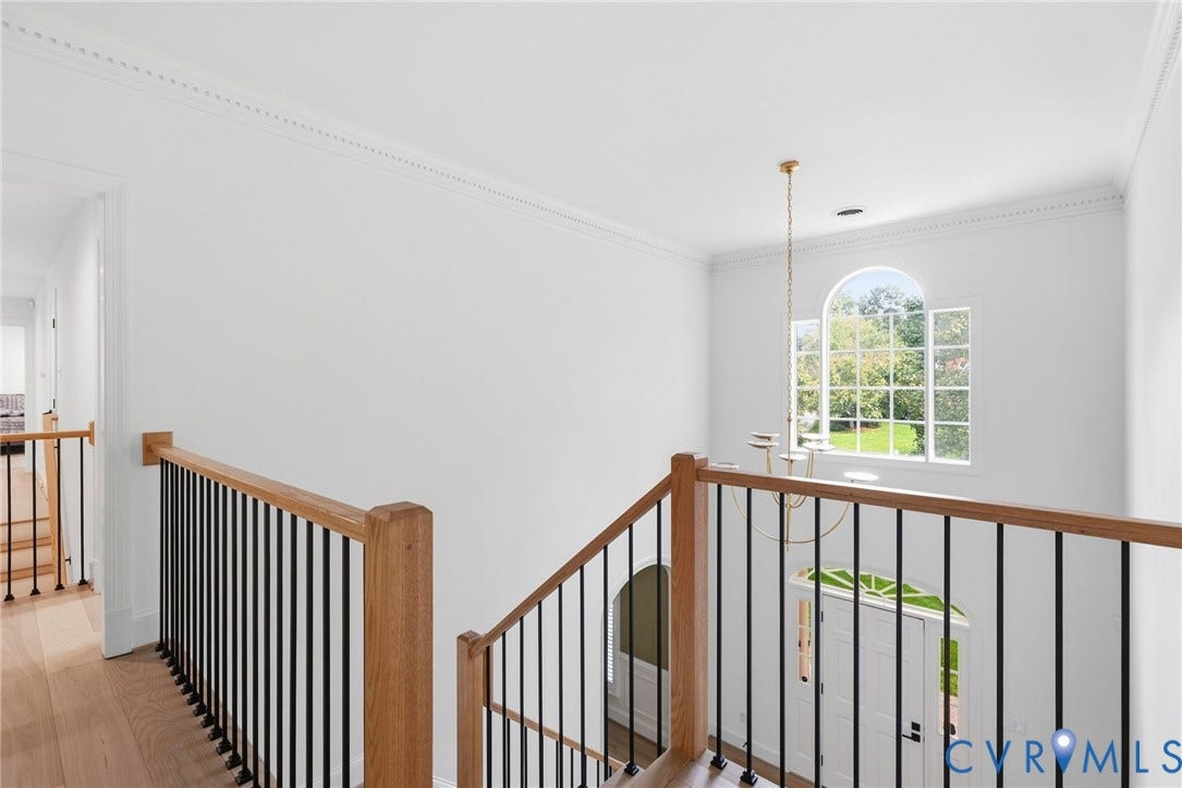 3808 Barrington Branch Court, Henrico, VA 23233 Hardwood flooring with a wood-finish staircase featuring black metal balusters and wood handrails