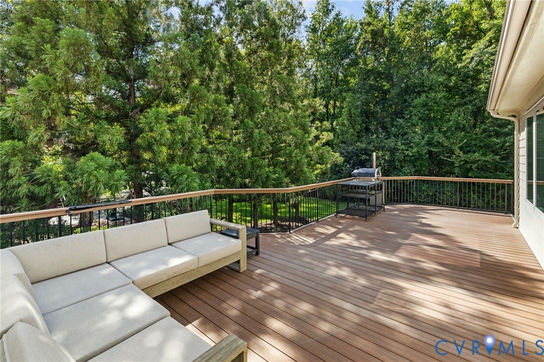 3808 Barrington Branch Court, Henrico, VA 23233 Expansive outdoor deck featuring wood-finish flooring and black metal railings with a wood top rail