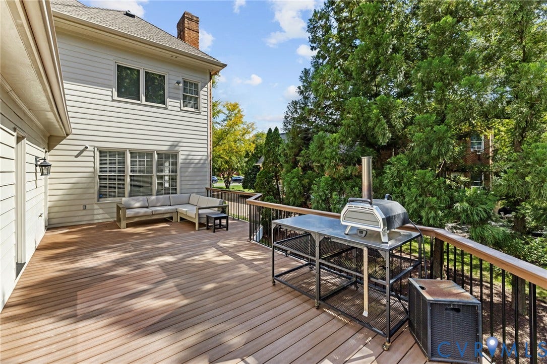 3808 Barrington Branch Court, Henrico, VA 23233 Expansive wood-finish deck with black metal railings and a wood-capped handrail