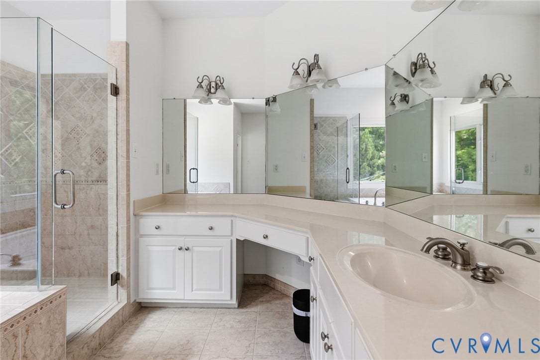 3808 Barrington Branch Court, Henrico, VA 23233 White vanity with integrated sink, brushed nickel faucet, and extensive mirror wall