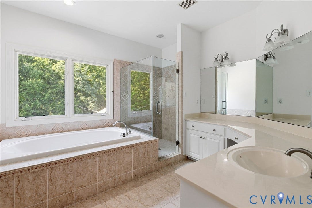 3808 Barrington Branch Court, Henrico, VA 23233 Soaking tub with tiled surround, walk-in shower with glass enclosure, dual vanity with undermount sink, and extensive countertop space