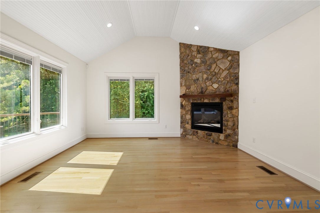3808 Barrington Branch Court, Henrico, VA 23233 Vaulted ceiling with beadboard finish, stone-clad fireplace with wood mantel, light wood-finish flooring, and multiple large windows