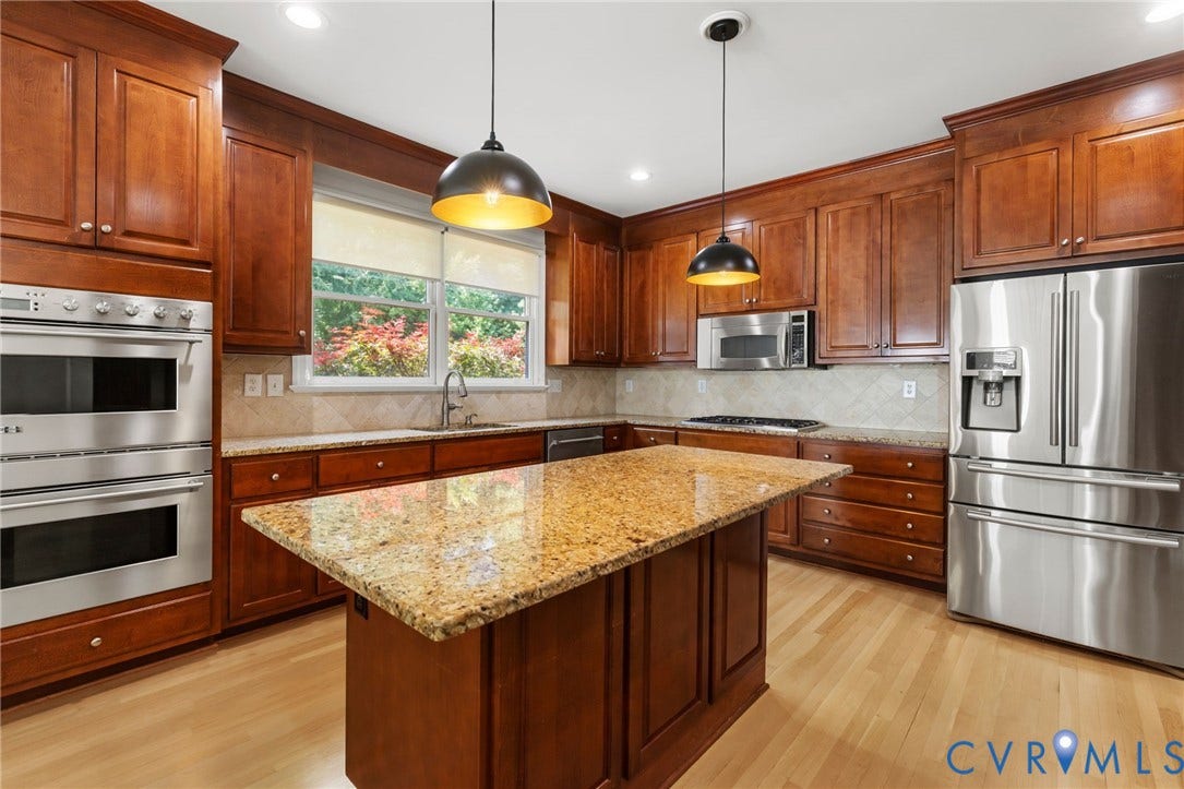 3808 Barrington Branch Court, Henrico, VA 23233 Cherry wood-finish cabinetry, light wood-finish flooring, stainless steel appliances, granite countertops, and a central island