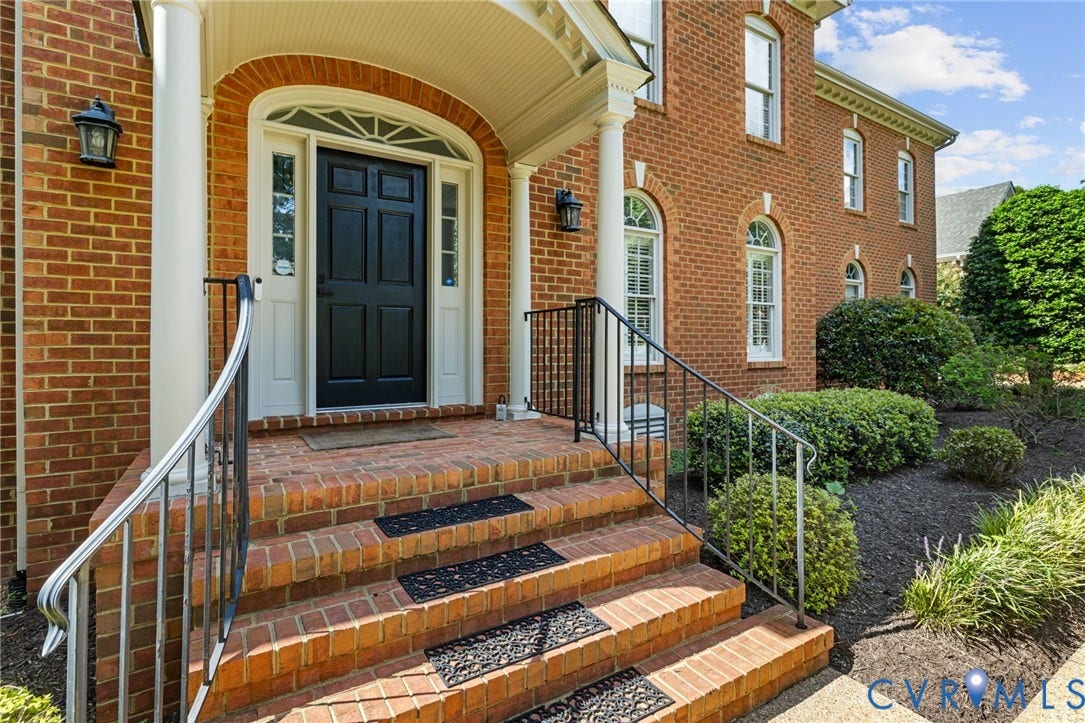 3808 Barrington Branch Court, Henrico, VA 23233 Brick exterior with arched windows, a covered entry, and a black paneled front door