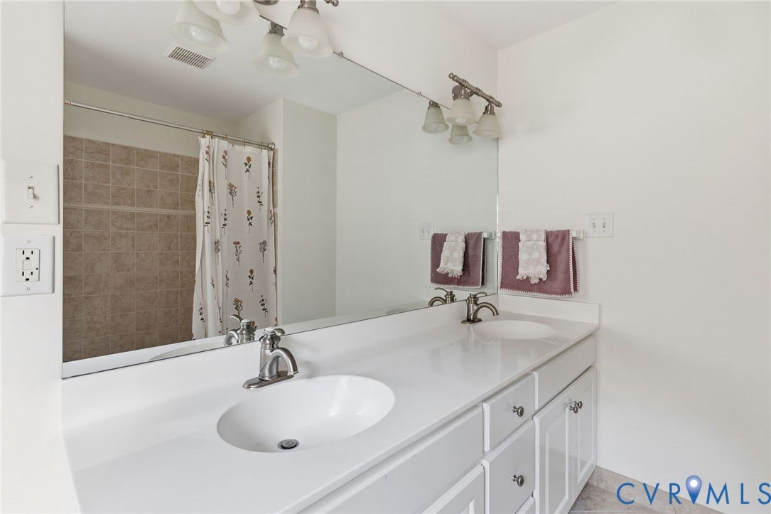 3808 Barrington Branch Court, Henrico, VA 23233 Double vanity with integrated sinks, brushed nickel fixtures, white cabinetry with silver-tone hardware, and a framed mirror