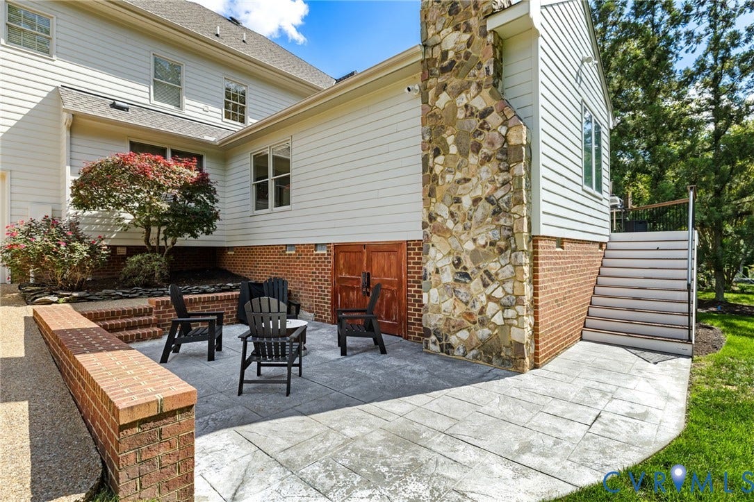 3808 Barrington Branch Court, Henrico, VA 23233 Stamped concrete patio with a brick retaining wall and stone chimney accent