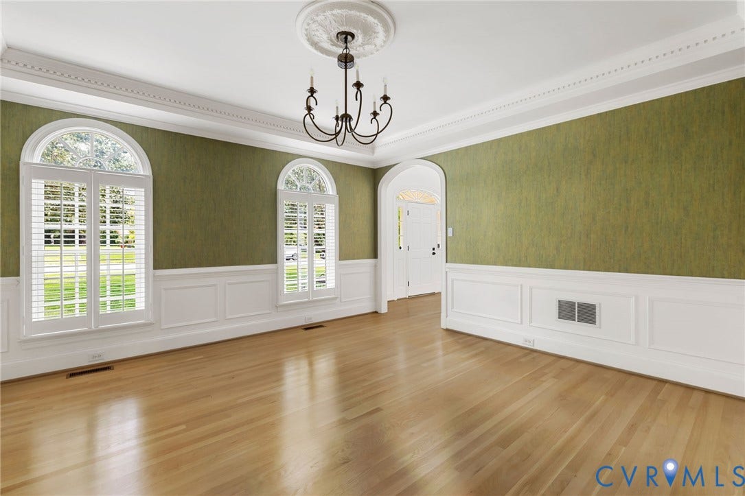 3808 Barrington Branch Court, Henrico, VA 23233 Hardwood flooring, arched windows with plantation shutters, decorative wainscoting, intricate crown molding, and a ceiling medallion with a chandelier