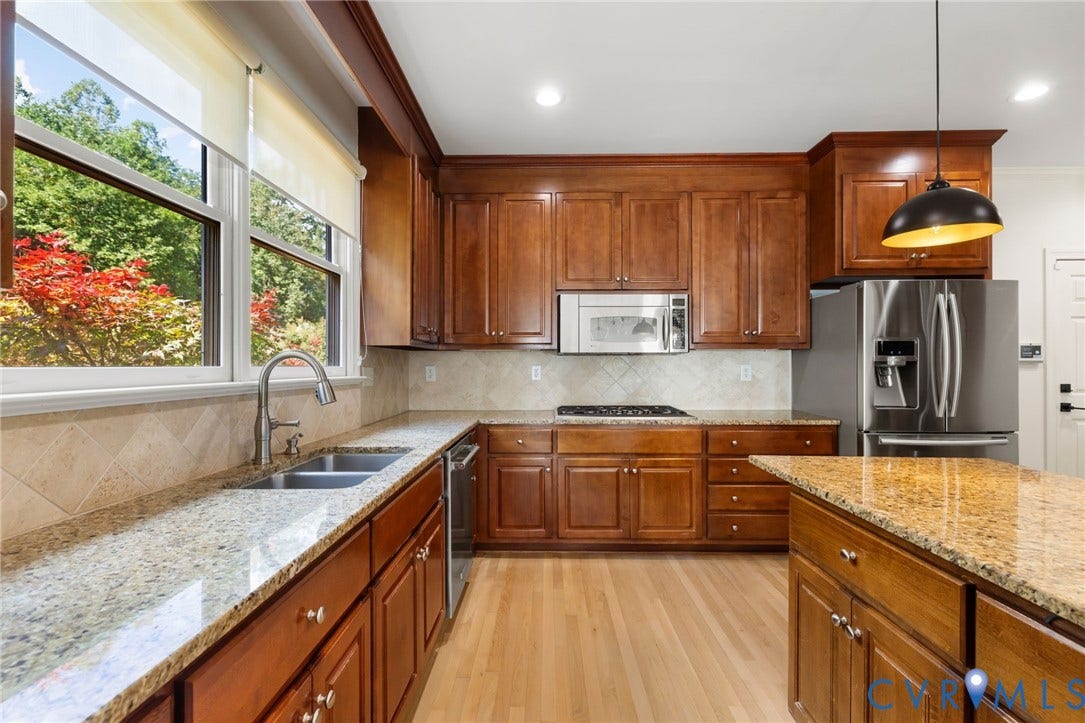 3808 Barrington Branch Court, Henrico, VA 23233 Kitchen featuring wood cabinetry, stainless steel appliances, speckled stone countertops, and light wood-finish flooring
