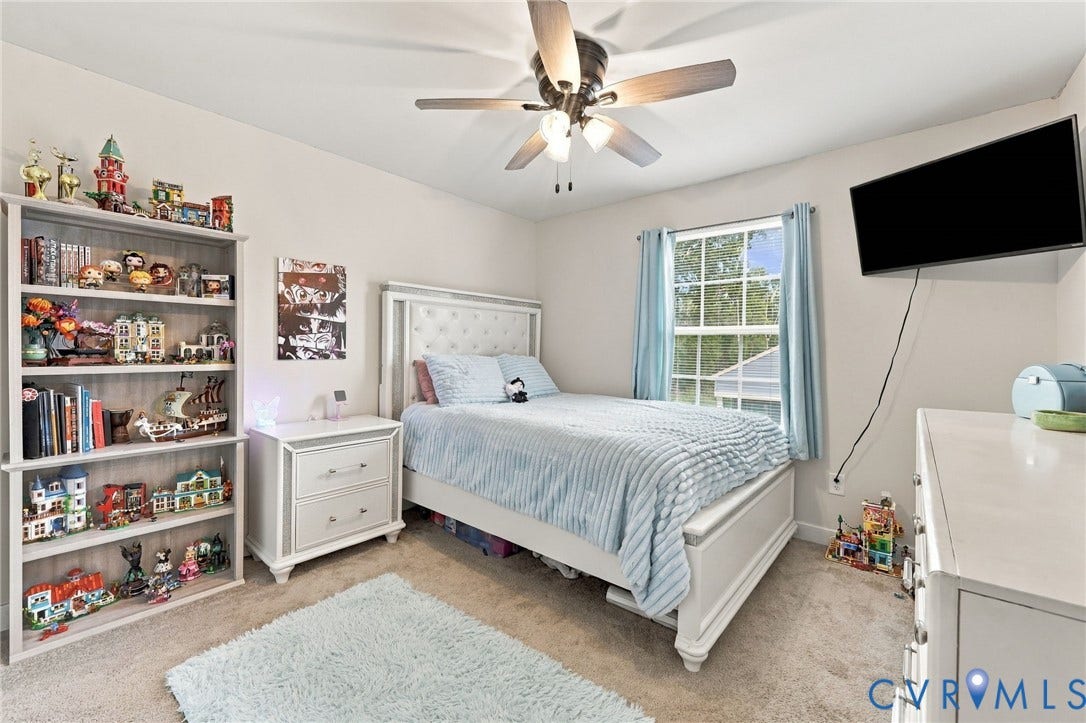 Recessed lighting, ceiling fan with light fixture, carpeted flooring, and a large window