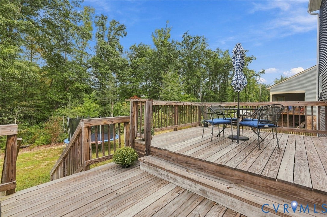 Expansive multi-level wood deck featuring wood railing and steps