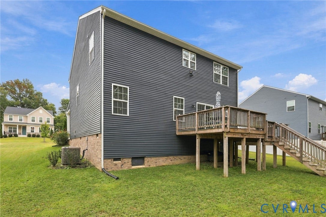 Raised wood deck with railings and staircase