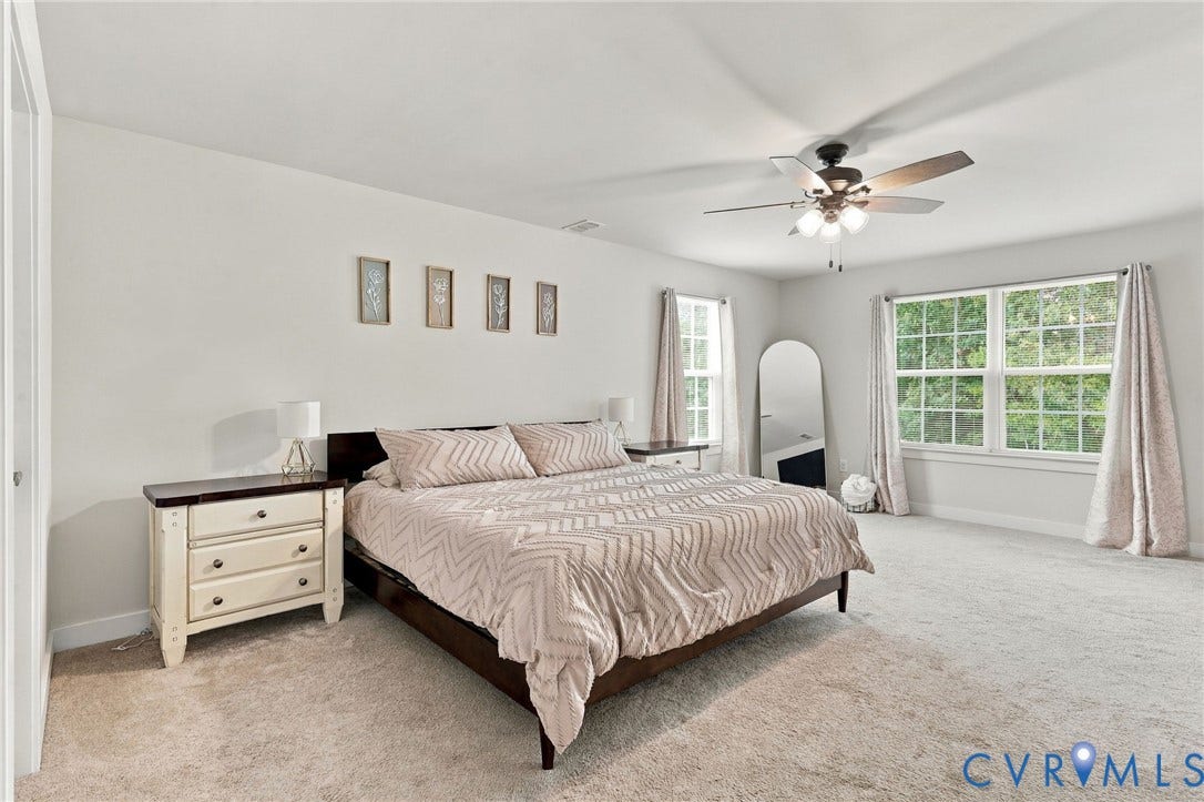 Carpeted flooring, recessed lighting, ceiling fan with light fixture, and multiple windows