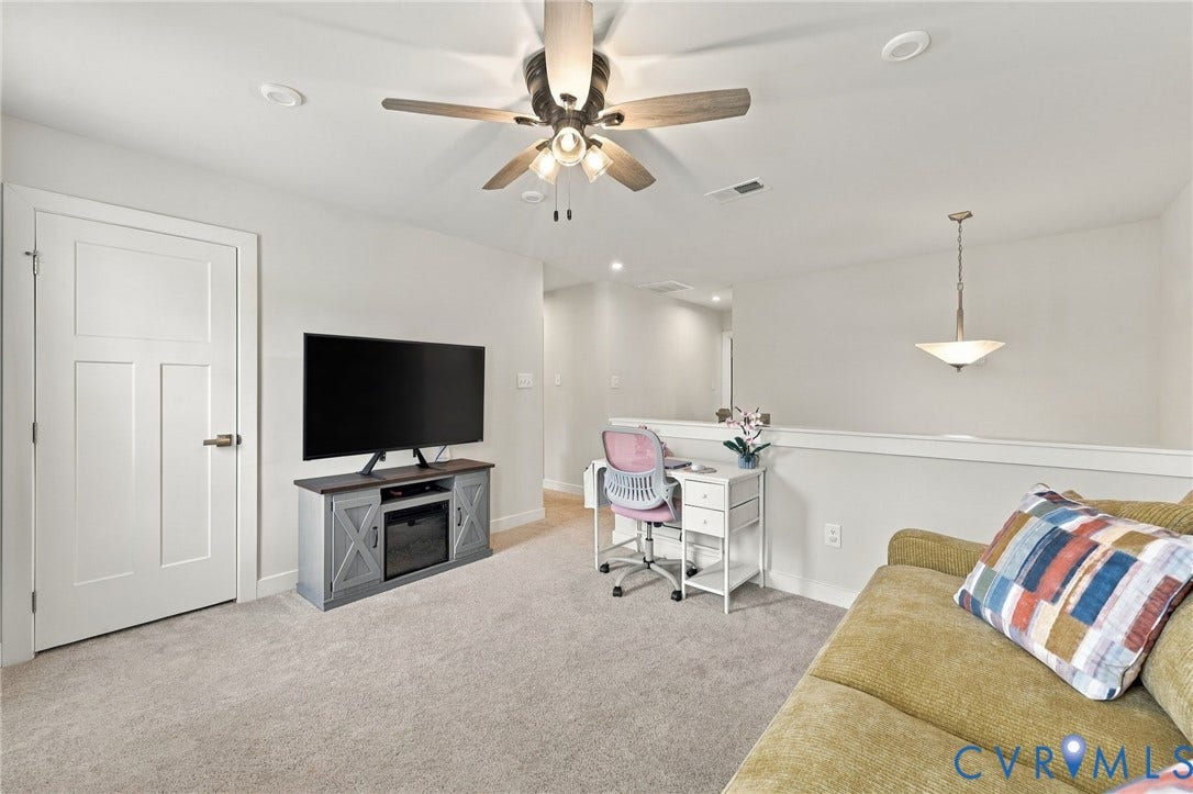 Recessed lighting, ceiling fan, carpet flooring, a white interior door, and a hanging pendant light