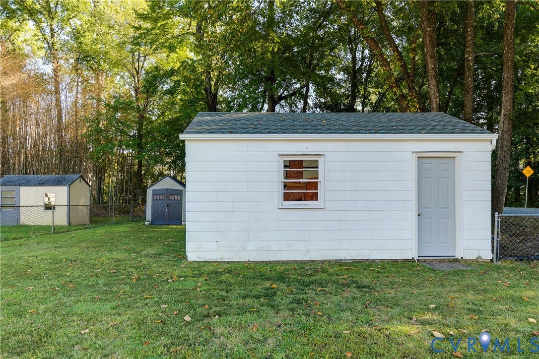 Detached storage shed with a new roof (2026), providing convenient space for yard tools and seasonal items.