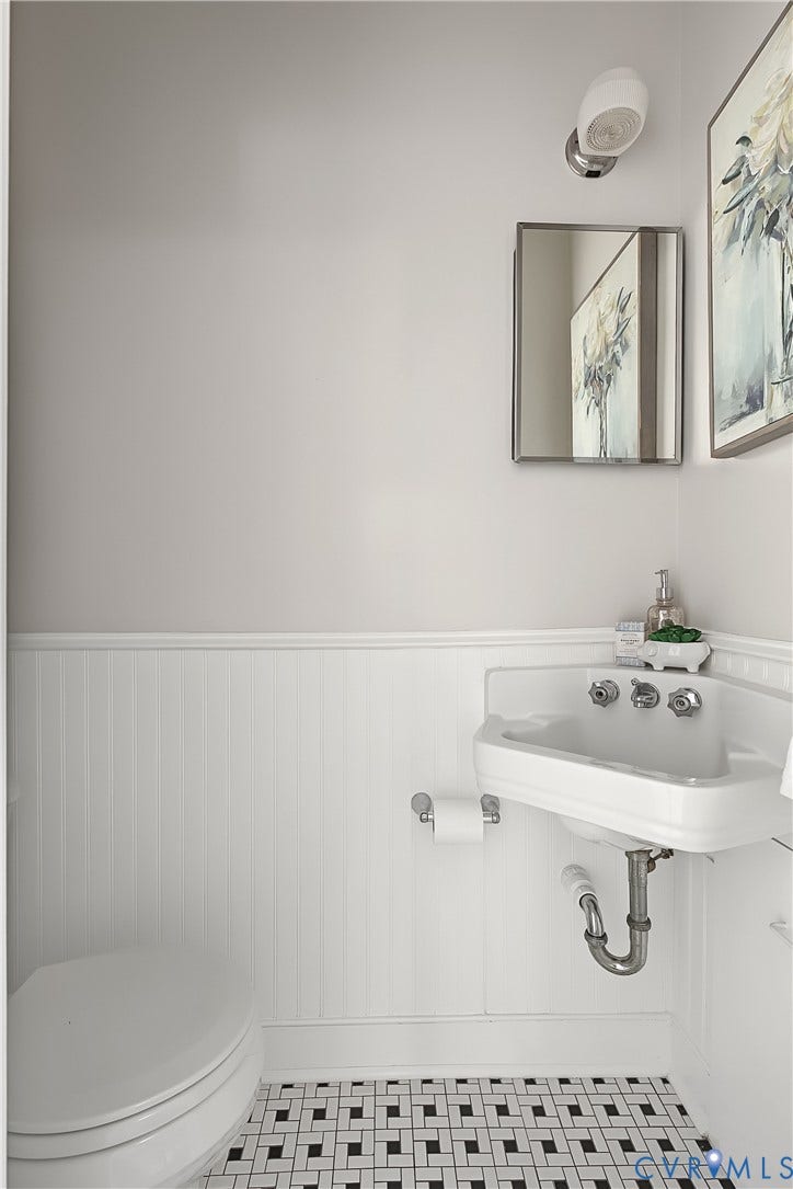 Private primary half bath with a pedestal sink
