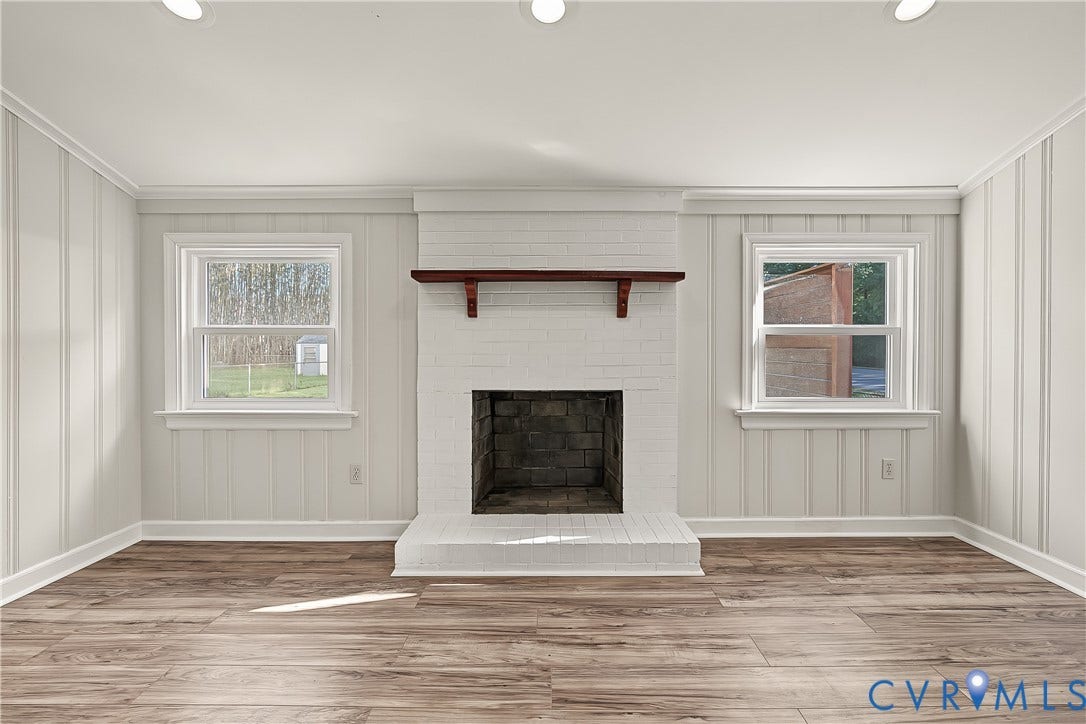 Inviting second living area with a brick fireplace and durable flooring