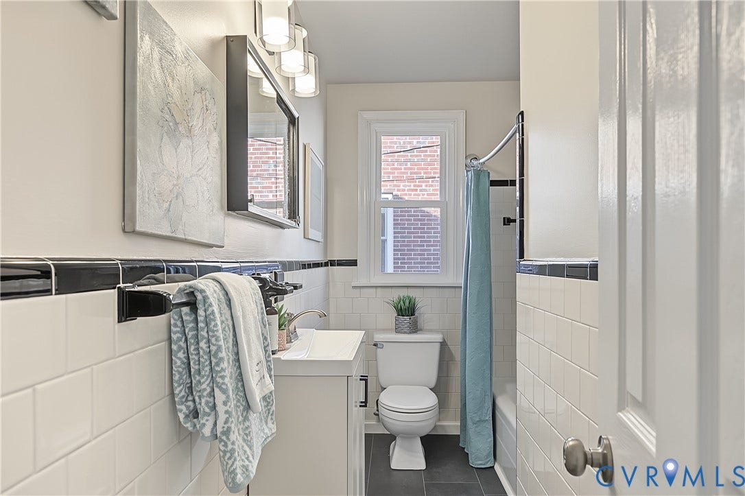 Refreshed bathroom with a vanity and new flooring (2026).