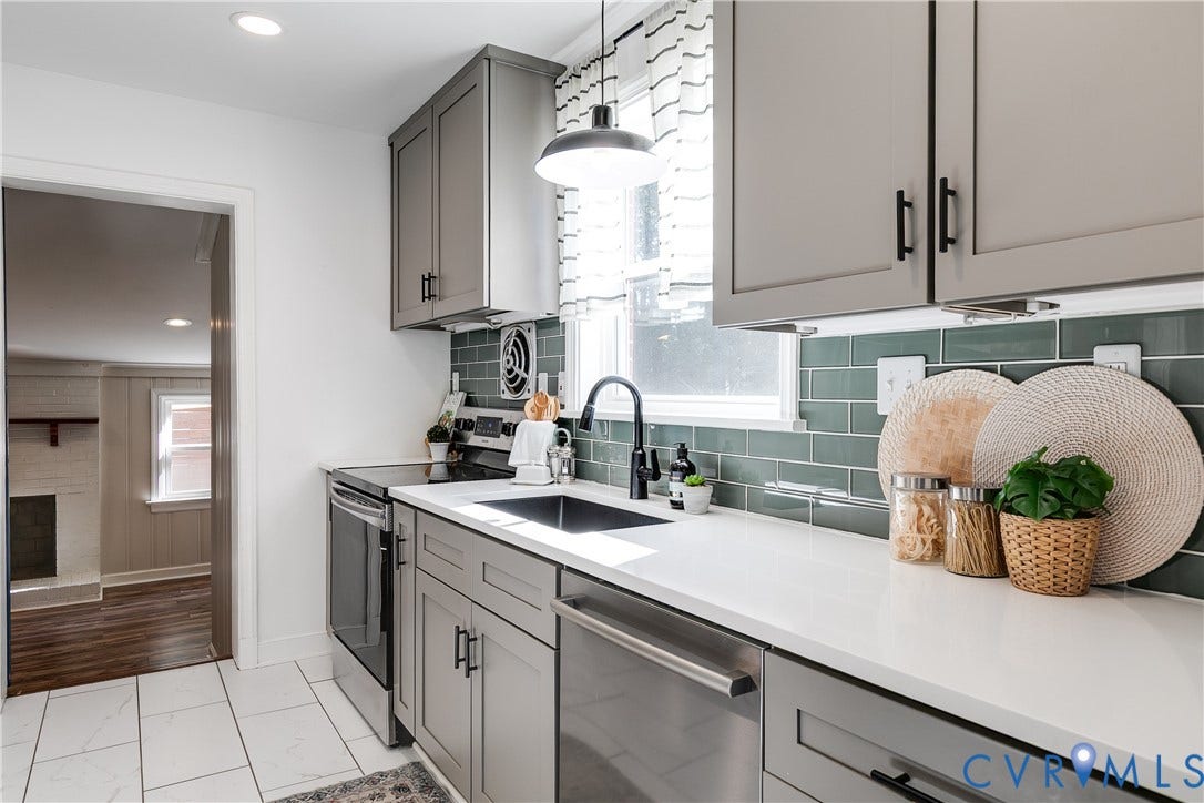 Quartz countertops and stainless steel appliances bring a fresh, contemporary look to this ranch kitchen