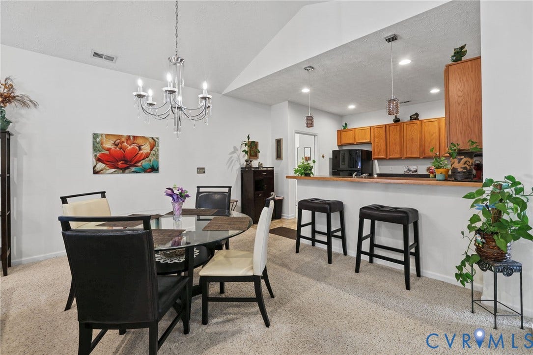 251 Pumpkin Place, Harvest Glen, North Chesterfield, VA 23236 Open-concept living and dining area featuring vaulted ceilings with recessed lighting, a pendant chandelier, neutral carpet flooring, and wood-finish cabinetry
