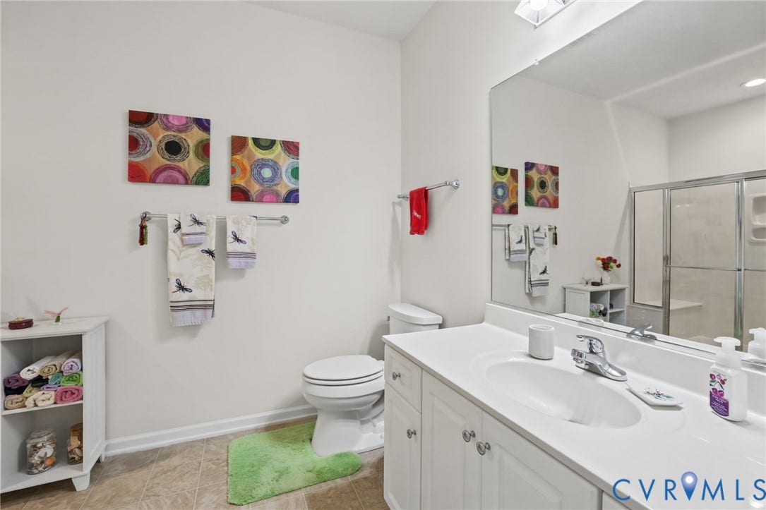 251 Pumpkin Place, Harvest Glen, North Chesterfield, VA 23236 Bathroom featuring a shower with a clear glass enclosure, white vanity with a single basin, a large wall-mounted mirror, and tile flooring