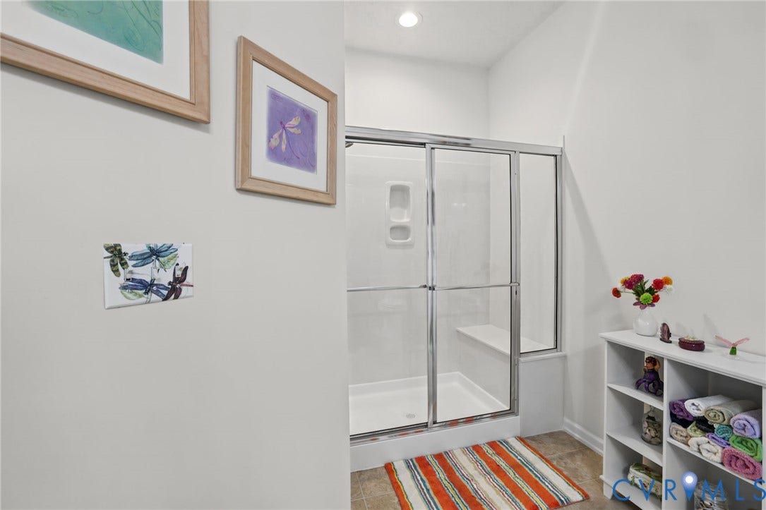251 Pumpkin Place, Harvest Glen, North Chesterfield, VA 23236 Spa-inspired ensuite bathroom featuring a frameless glass walk-in shower enclosure with chrome hardware, wood-finish flooring, built-in shelving with organizational cubbies, and recessed ceiling lighting